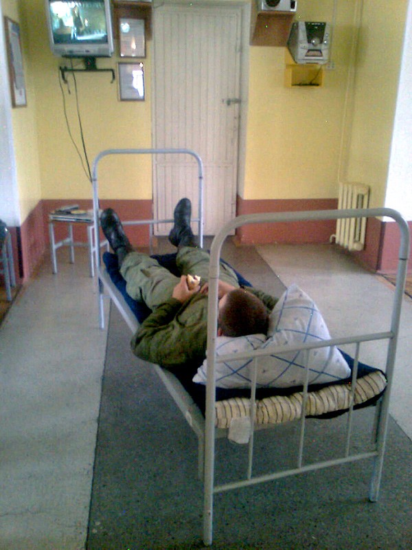 Một quân nhân Nga nằm nghỉ ngơi trên tay cầm một chiếc bánh mỳ ăn dở
